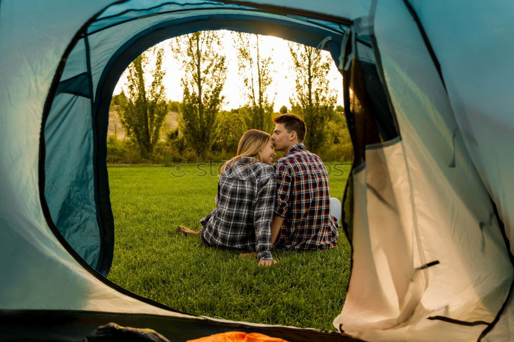 Similar – Couple planning next trip while sitting with map in tent. People relaxing in tent at camping during summer vacation