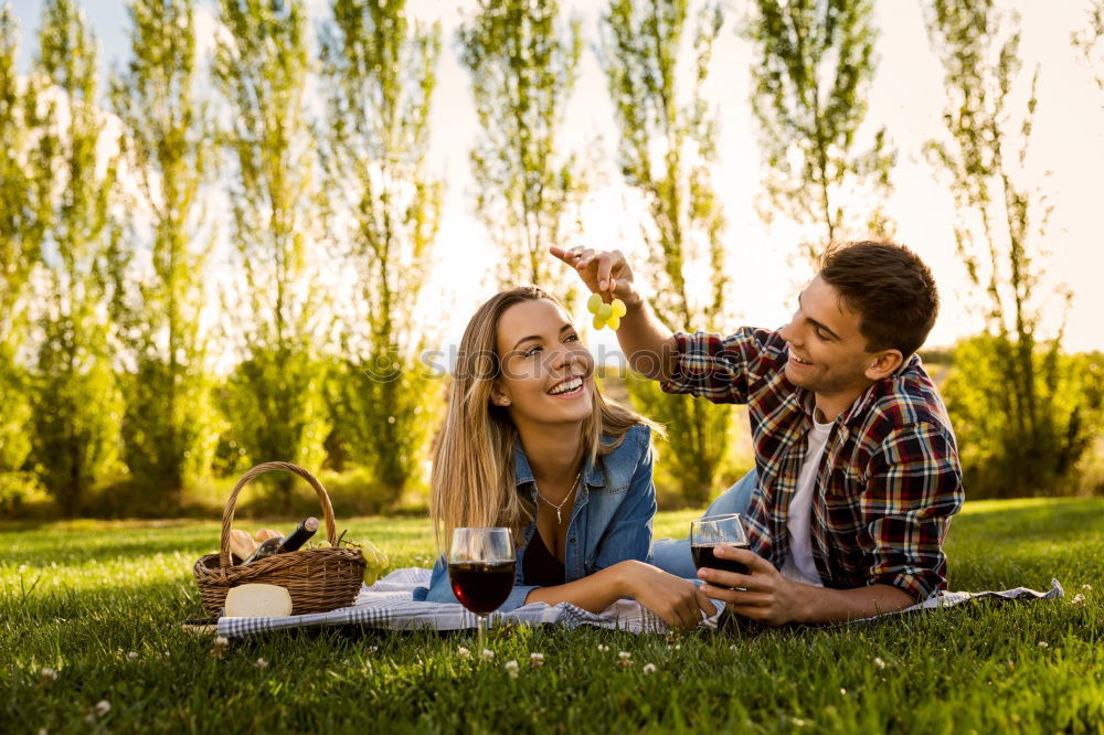 Similar – Beautiful young couple laying on grass in an urban park