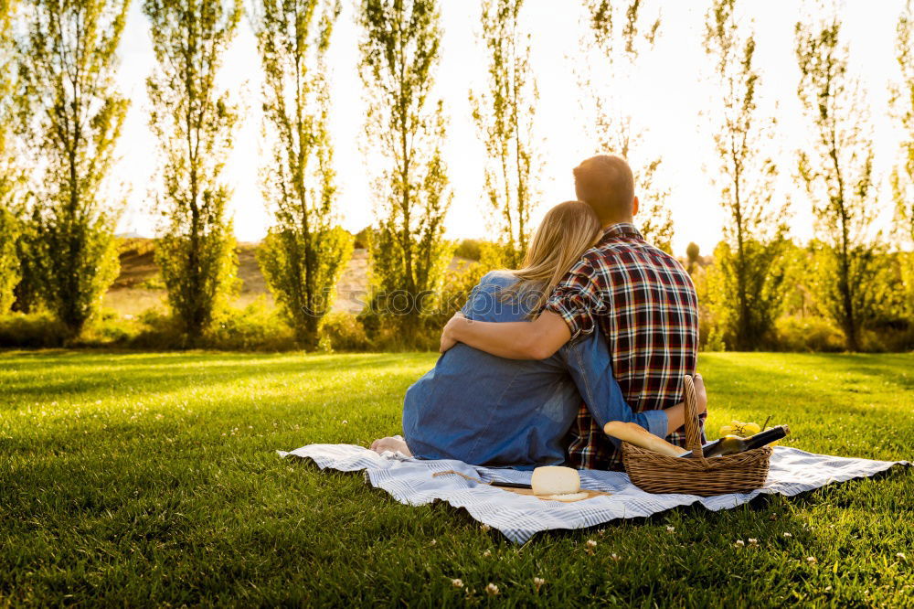 Similar – Image, Stock Photo 2 seniors in love are sitting on a bench in the vineyard and look into the Ahr valley. The man points to something.