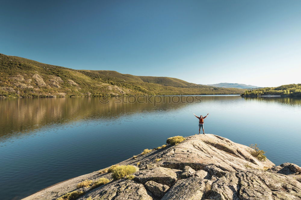 Similar – Mountain lake, woman standing