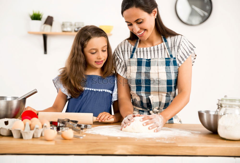 Similar – Image, Stock Photo Little sisters cooking with her mother in the kitchen.