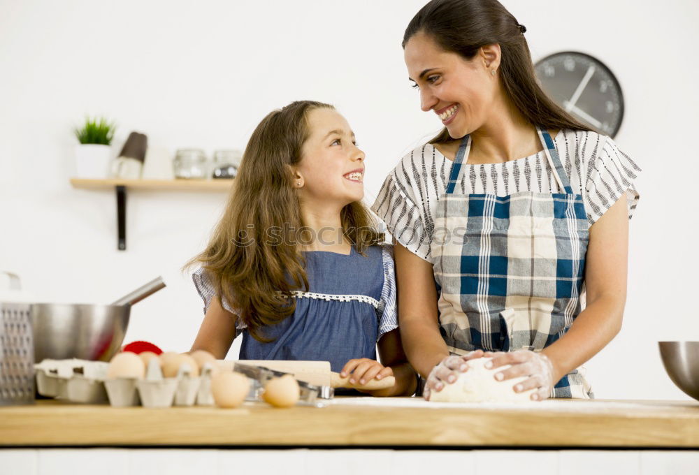 Similar – Image, Stock Photo Little sisters cooking with her mother in the kitchen.