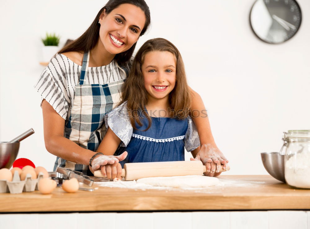 Similar – Image, Stock Photo Little girl cooking with her mother in the kitchen.