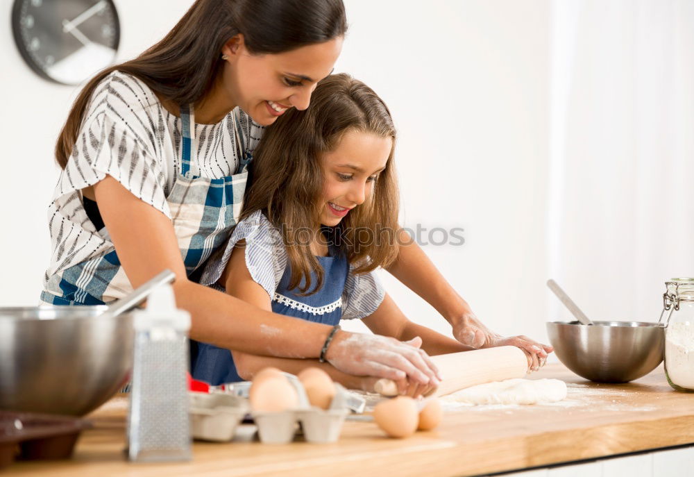 Similar – Image, Stock Photo Little sisters cooking with her mother in the kitchen.
