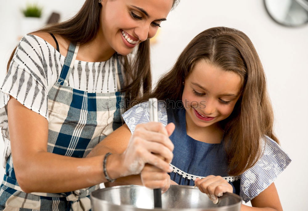 Similar – Image, Stock Photo Little sisters cooking with her mother in the kitchen.