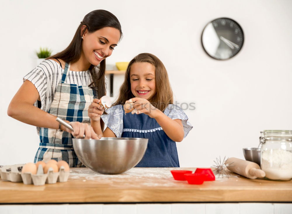 Similar – Image, Stock Photo Little sisters cooking with her mother in the kitchen.