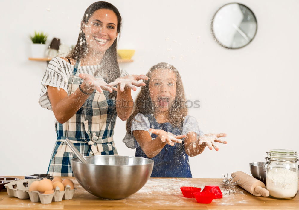 Similar – Image, Stock Photo Little sisters cooking with her mother in the kitchen.