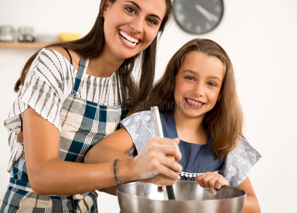 Similar – Image, Stock Photo Little girl cooking with her mother in the kitchen.