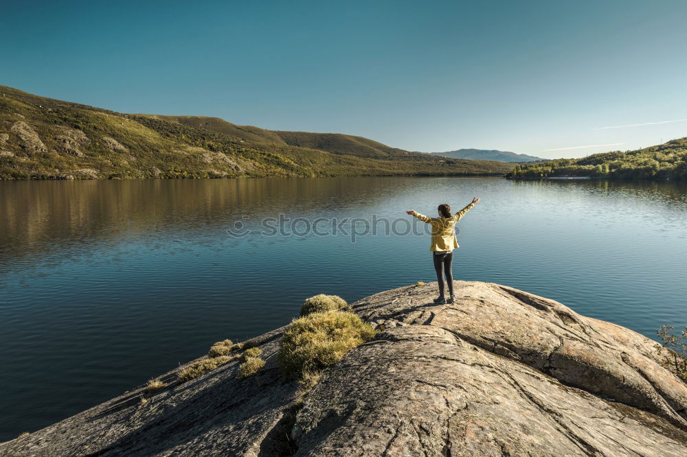 Similar – Mountain lake, woman standing