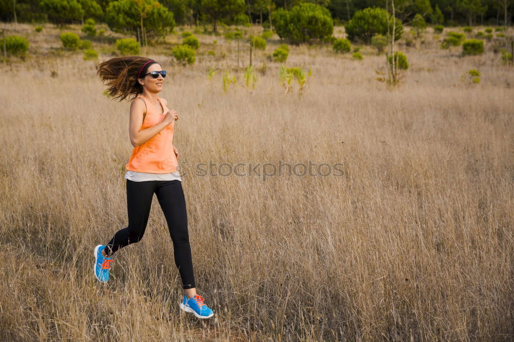 Similar – Fit middle-aged woman walking through a field