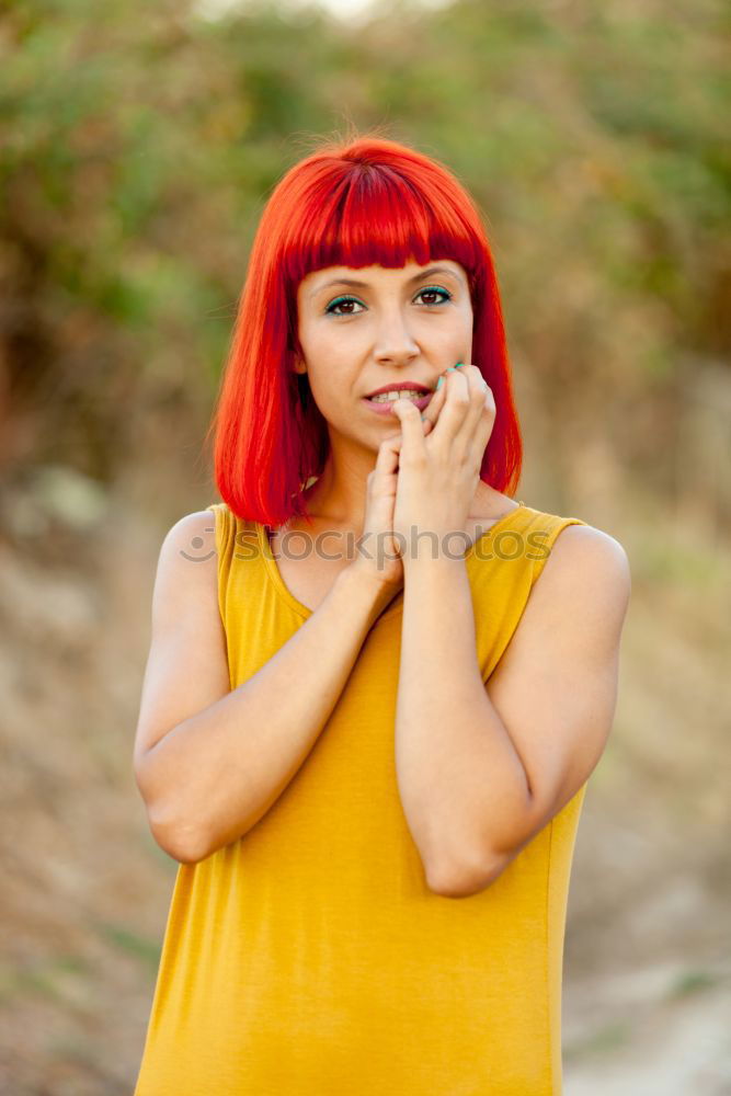 Similar – Redhead woman smelling a flower in a park