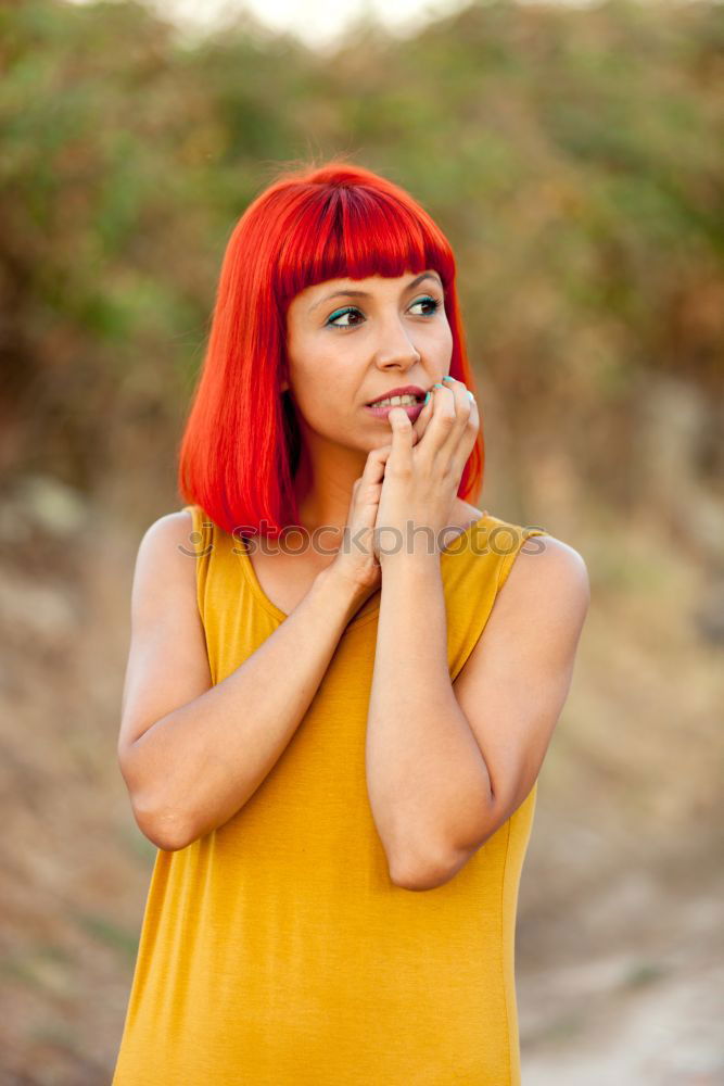 Similar – Redhead woman smelling a flower in a park