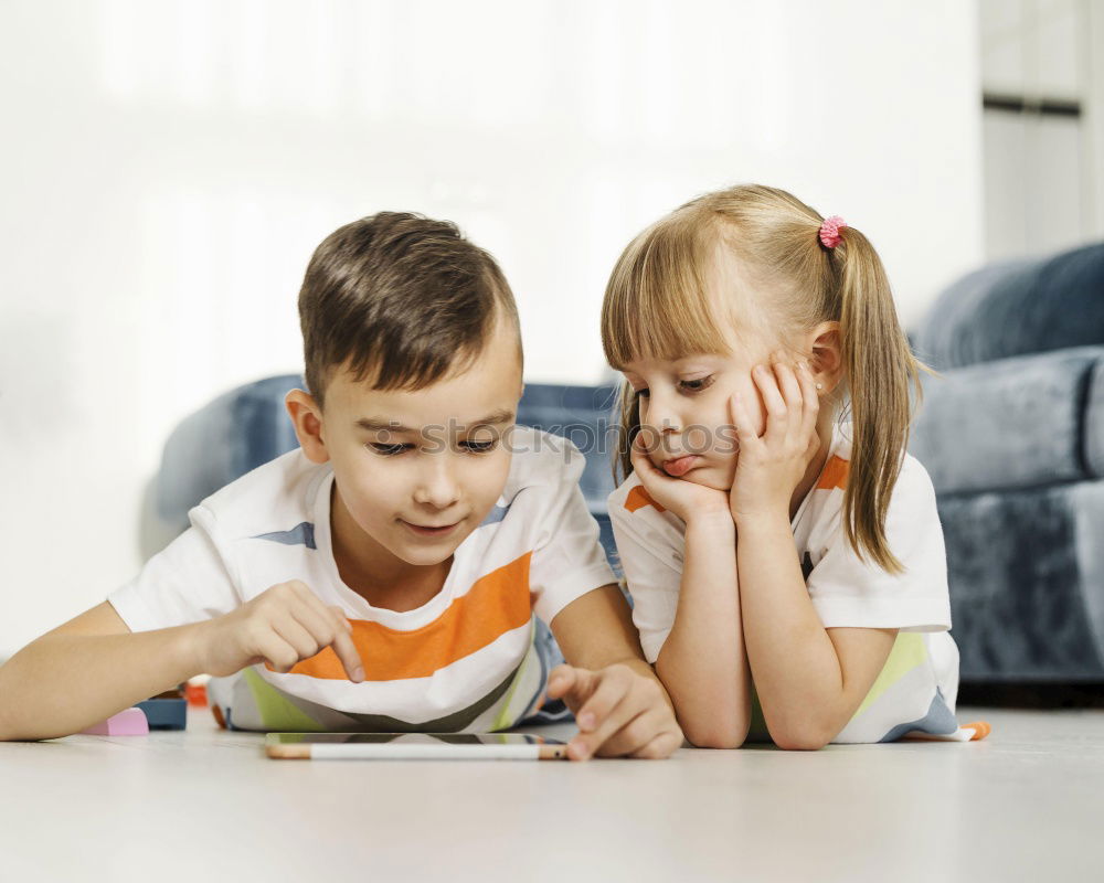 Similar – Three kids using a tablet at home