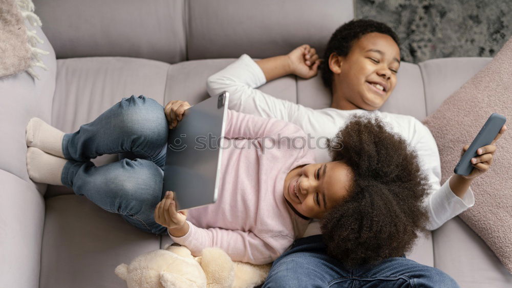 Similar – Happy mom and daughter using digital tablet together