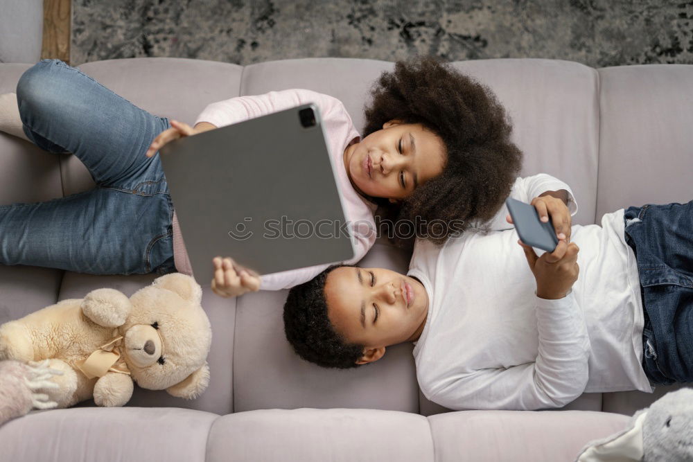 Similar – Mother reading a book to her baby son