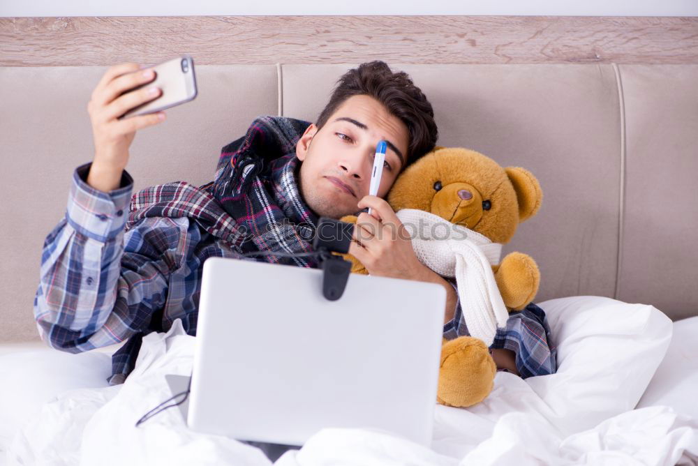 Similar – Young girl looking at mobile phone while sitting on bed