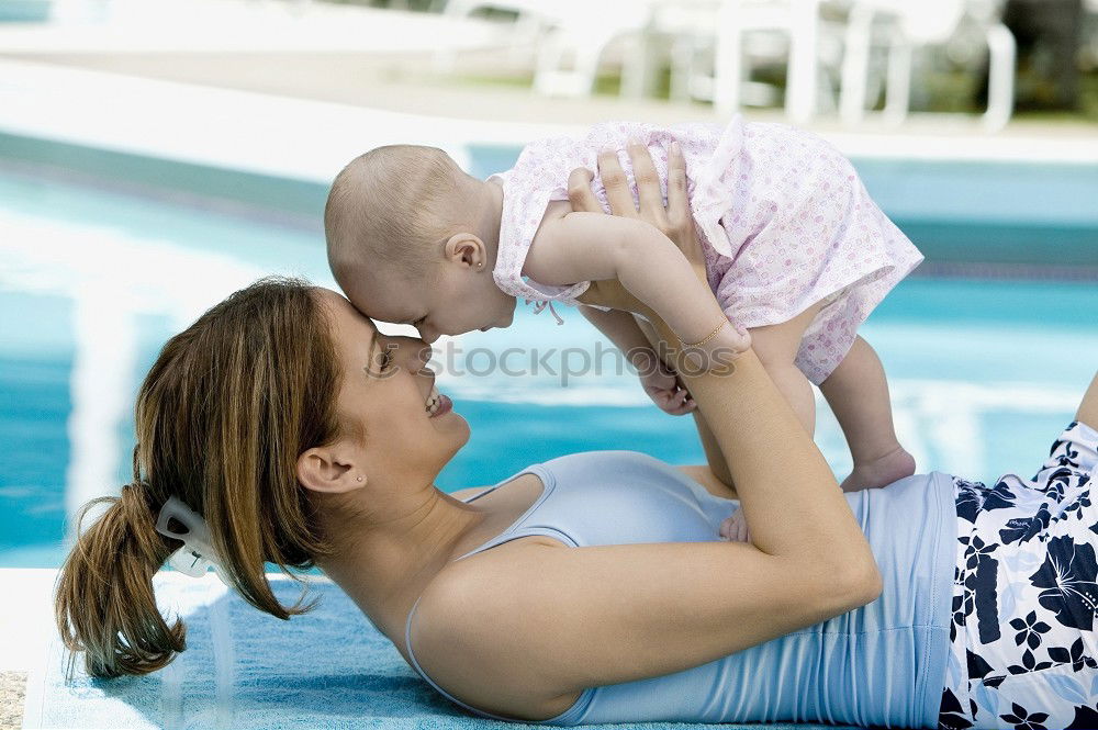 Similar – Teenage girl with her little sister spending time together in the swimming pool in a garden enjoy eating ice cream on a summer sunny day. Family quality time