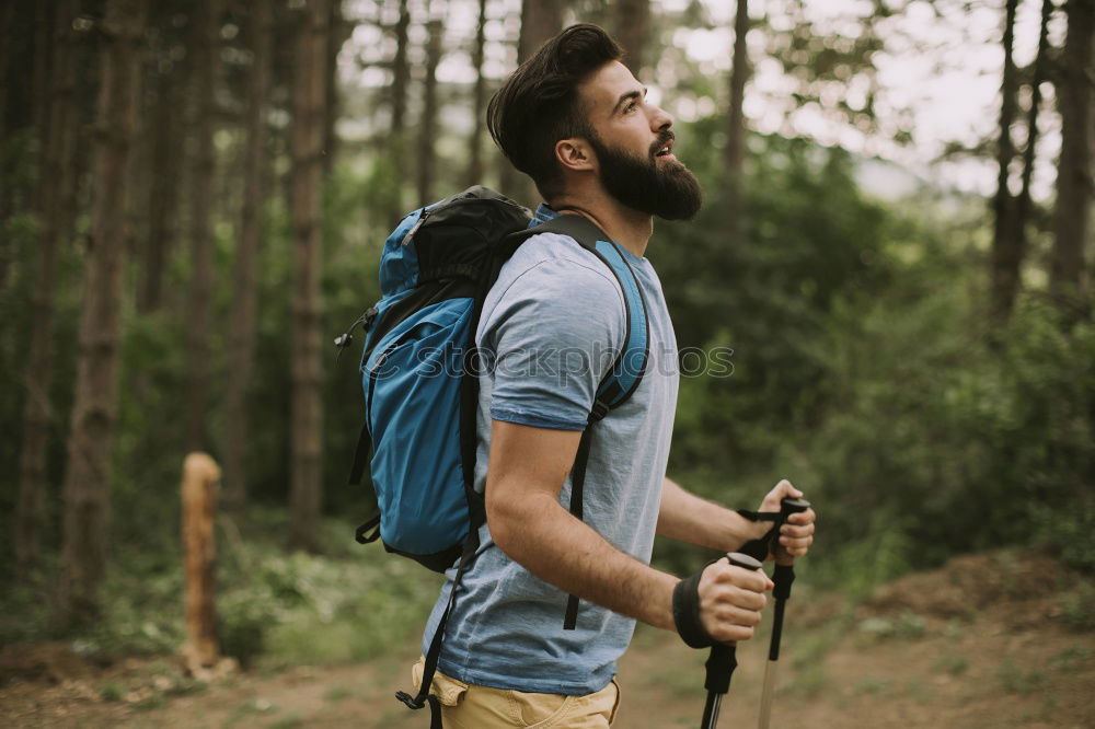 Similar – Man navigating on road in woods