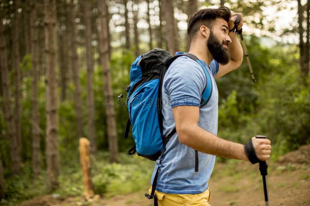 Similar – Man navigating on road in woods