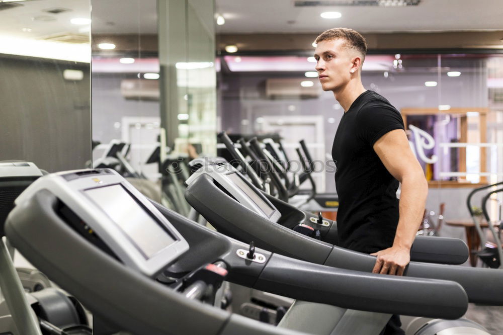 Similar – Image, Stock Photo Man setting control panel of treadmill for training