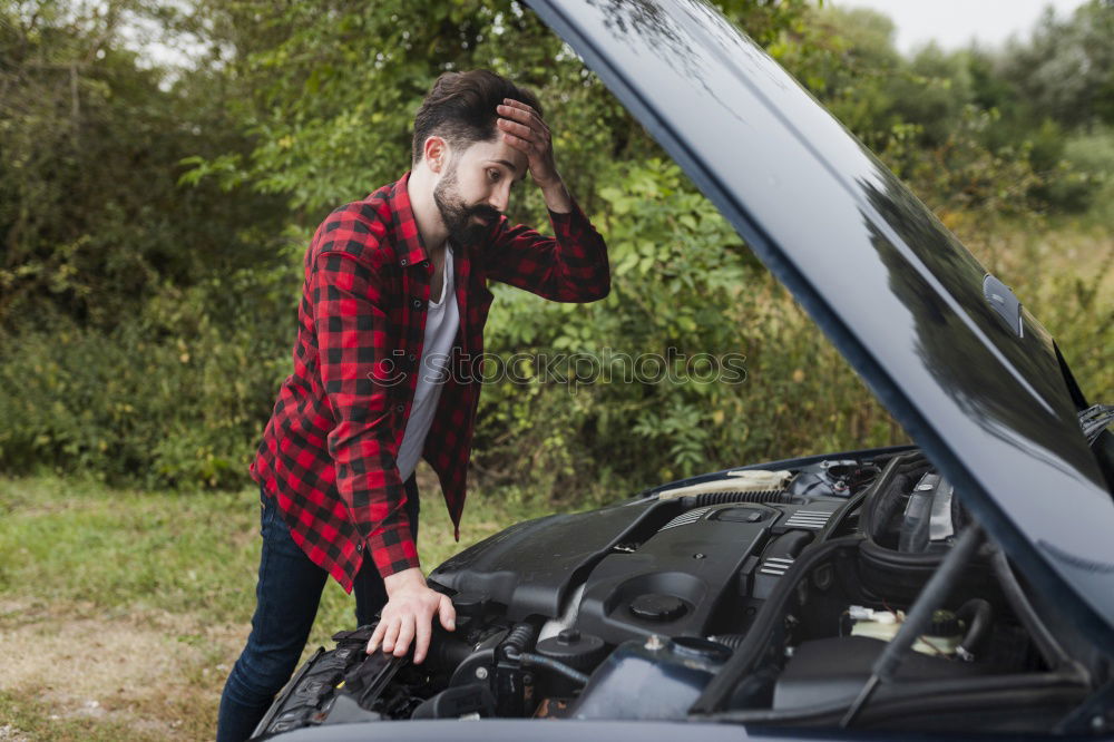 young guy repairing an old car