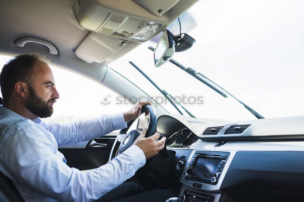 Similar – Image, Stock Photo Young man holding steering driving