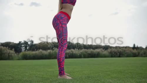 Similar – Woman stretching her body in front of ancient wall in park