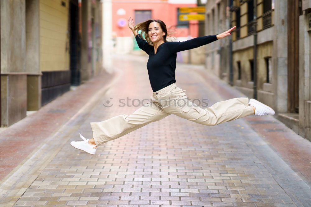 Similar – Image, Stock Photo Young happy woman jumping in the street