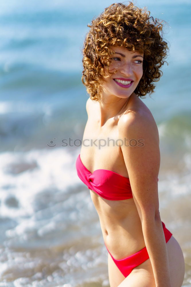 Similar – Young arabic woman with beautiful body in swimwear smiling on a tropical beach.