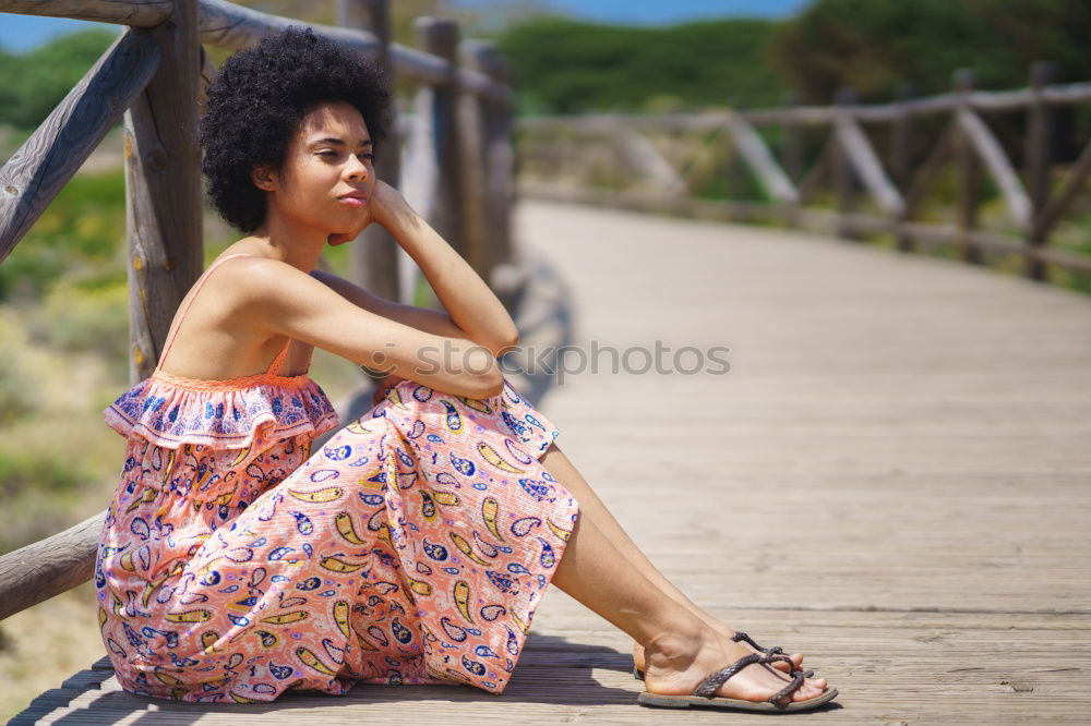 Similar – Image, Stock Photo Beautiful young black woman lying down in a  wooden foot bridge at the beach