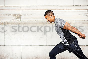 Similar – Black man running and listening to music in urban background