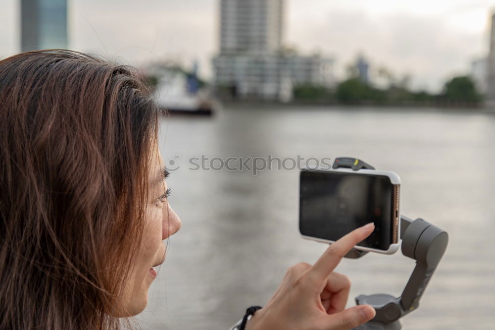 Similar – Image, Stock Photo two friends in the street taking pictures with mobile phone