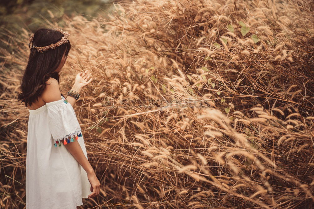 Similar – Young woman in almond flowered field in spring time