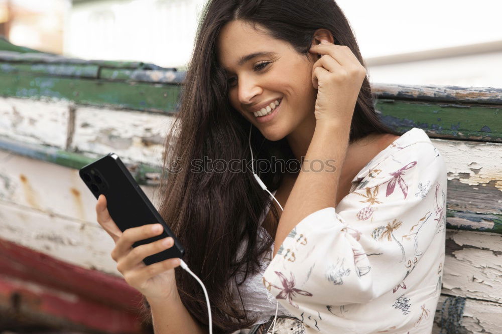 Happy caucasian women listening to music on smart phone