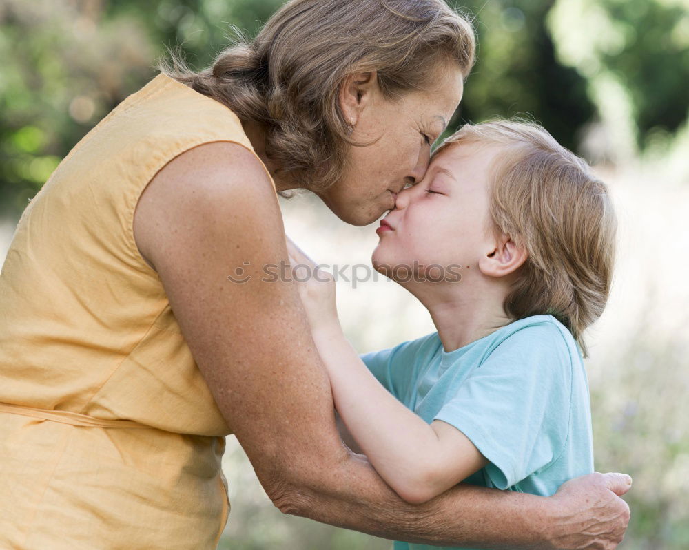 Boy kissing his grandmother