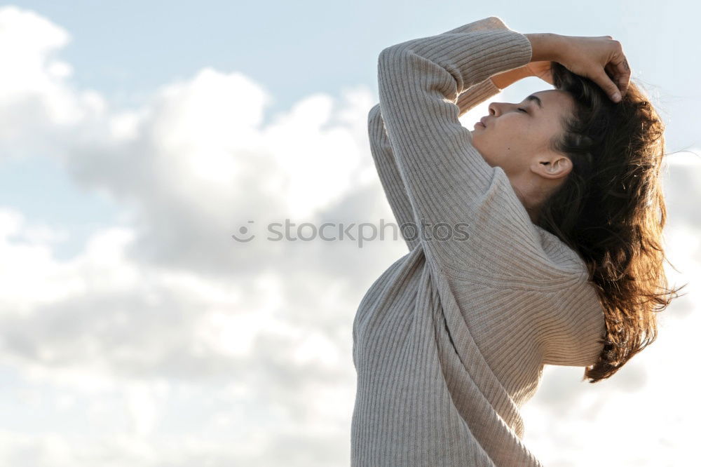 Similar – young hooded woman in a white sweatshirt with a serious look