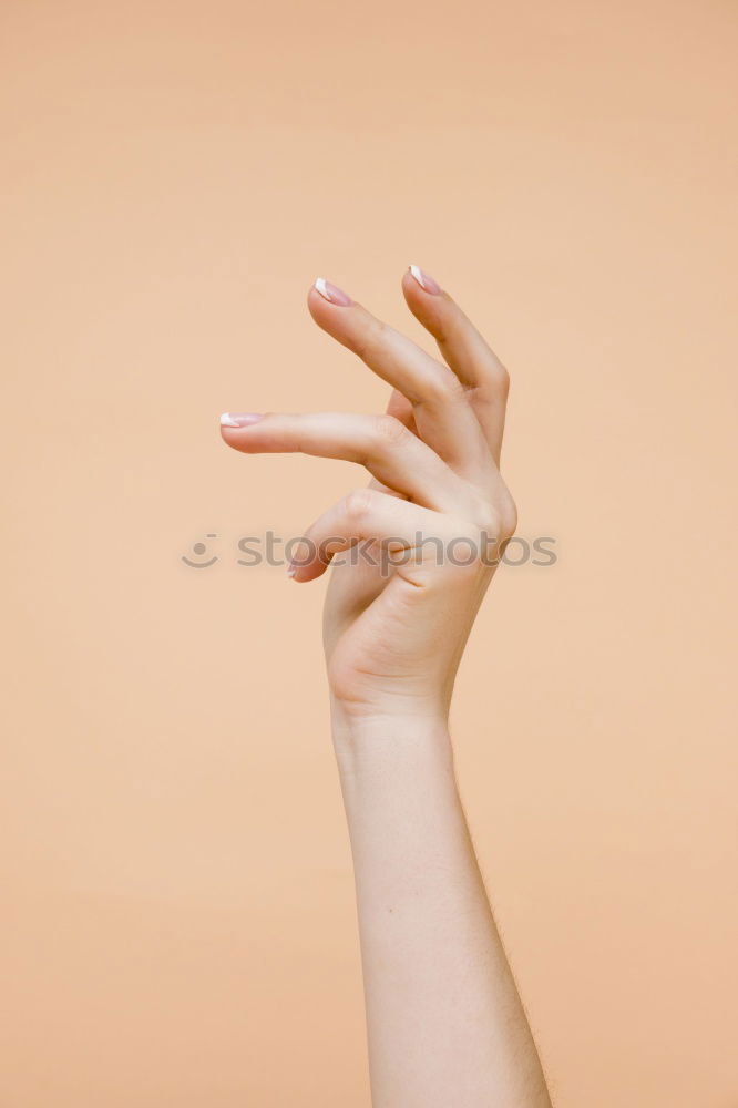 Similar – Image, Stock Photo Forearm and hand with spread fingers against a yellow background