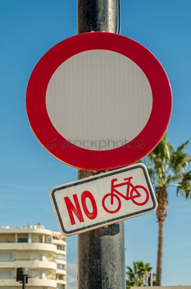 Similar – Signs I In front of a yellow house on the left and right side of the road there are traffic signs