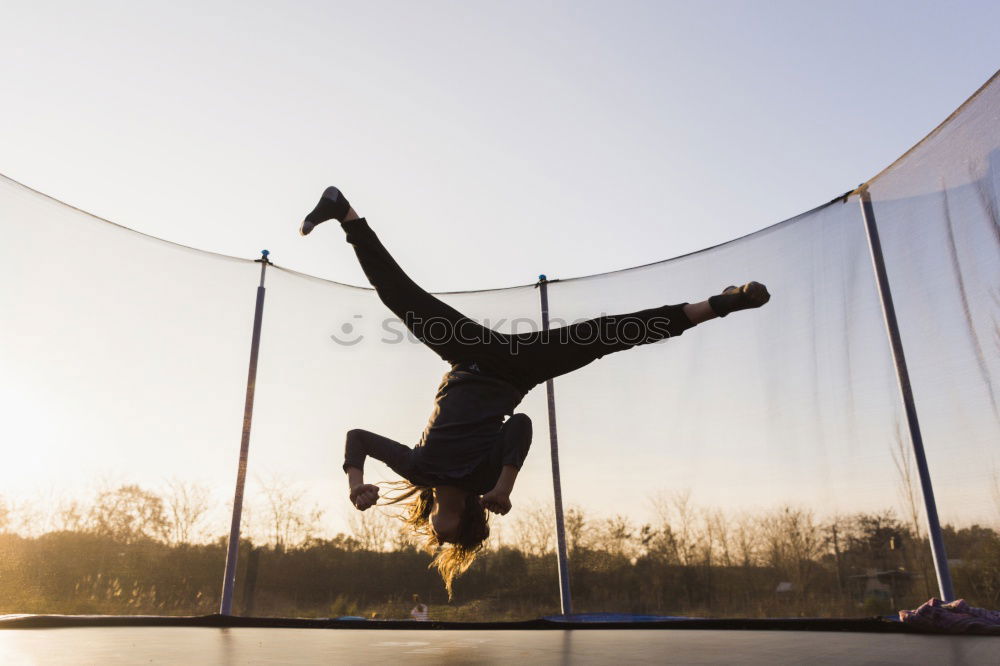 Similar – Athletic man balancing on gymnastic rings