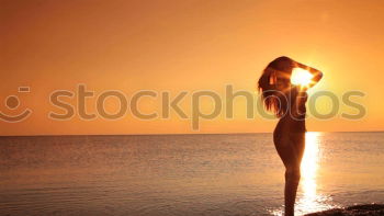 Similar – Happy little girl jumping on the beach at the sunset time