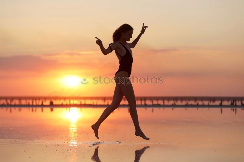 Similar – Happy little girl jumping on the beach at the sunset time