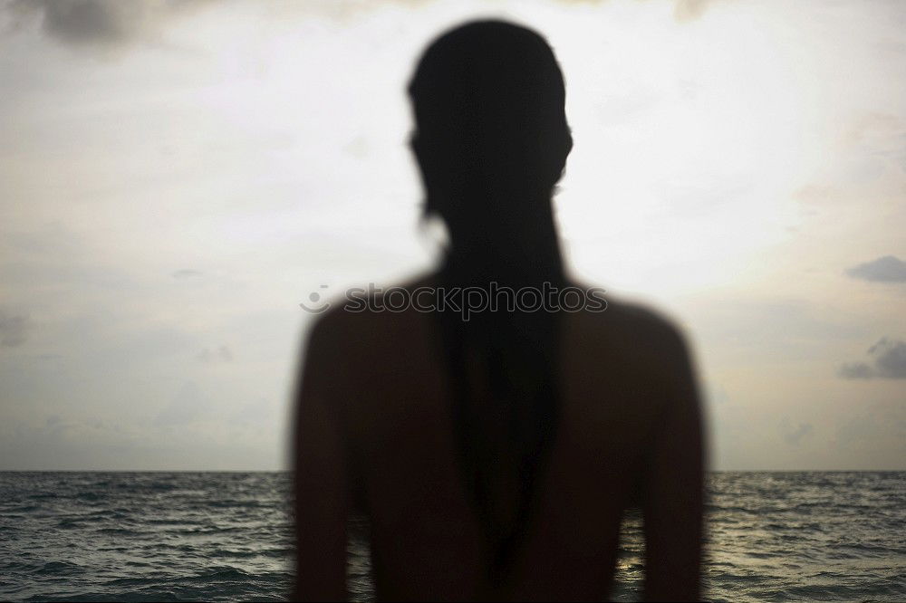 young woman in depression near the window