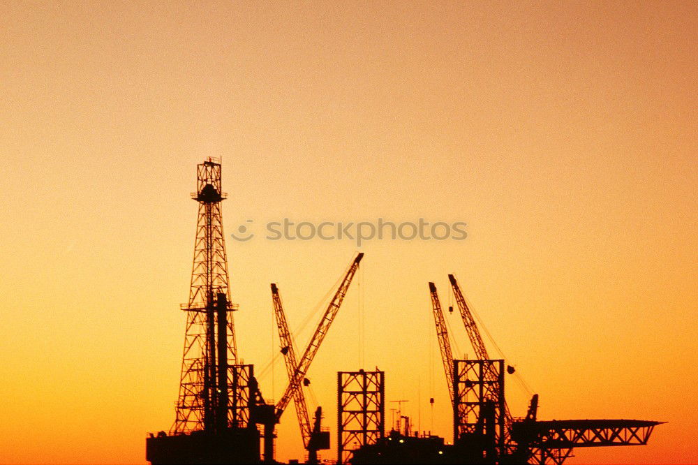 Similar – Truck cranes on rails in the orange evening sky