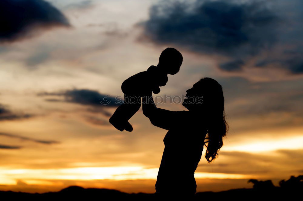 Similar – Father and son playing on the beach at the sunset time.