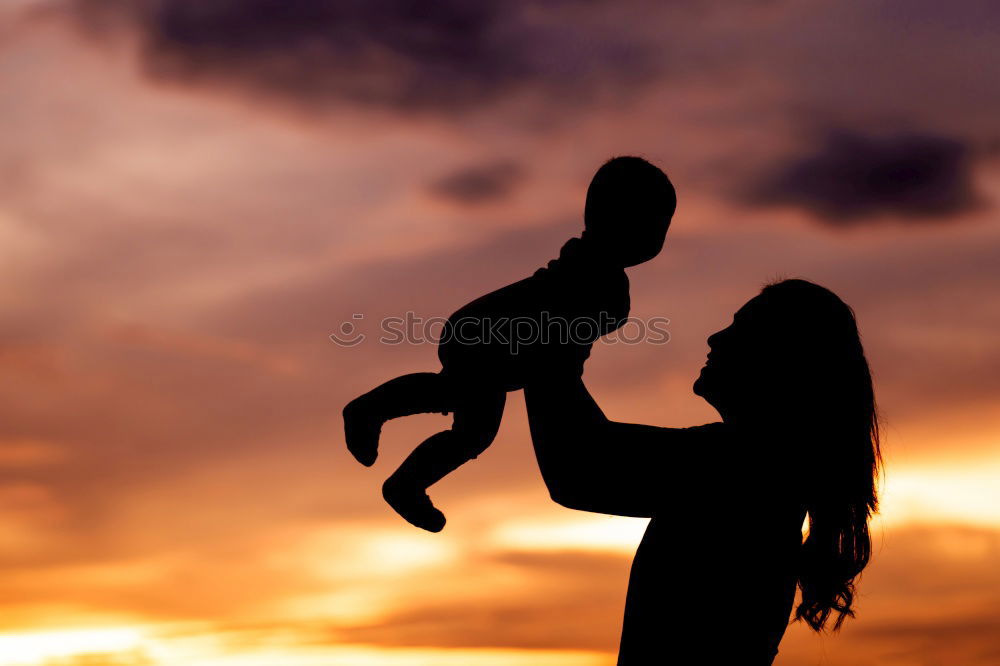 Similar – Father and son playing on the beach at the sunset time.