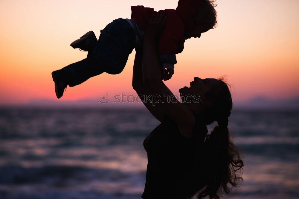 Similar – Father and son playing on the beach at the sunset time.