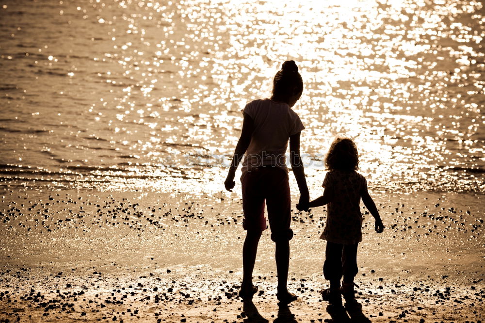 Similar – Father and son playing on the beach at the sunset time.