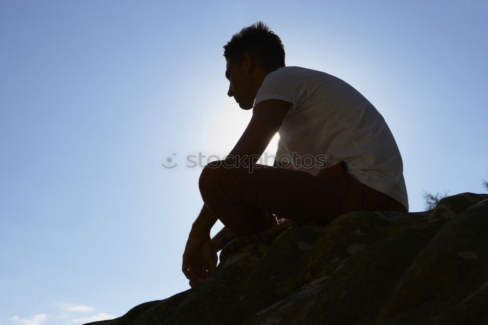 Man exhausted from a hike at a viewpoint