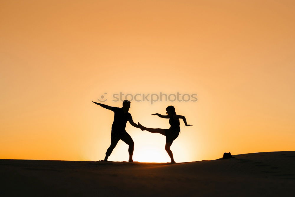 Similar – Mother and son holding hands on a beach at sunset