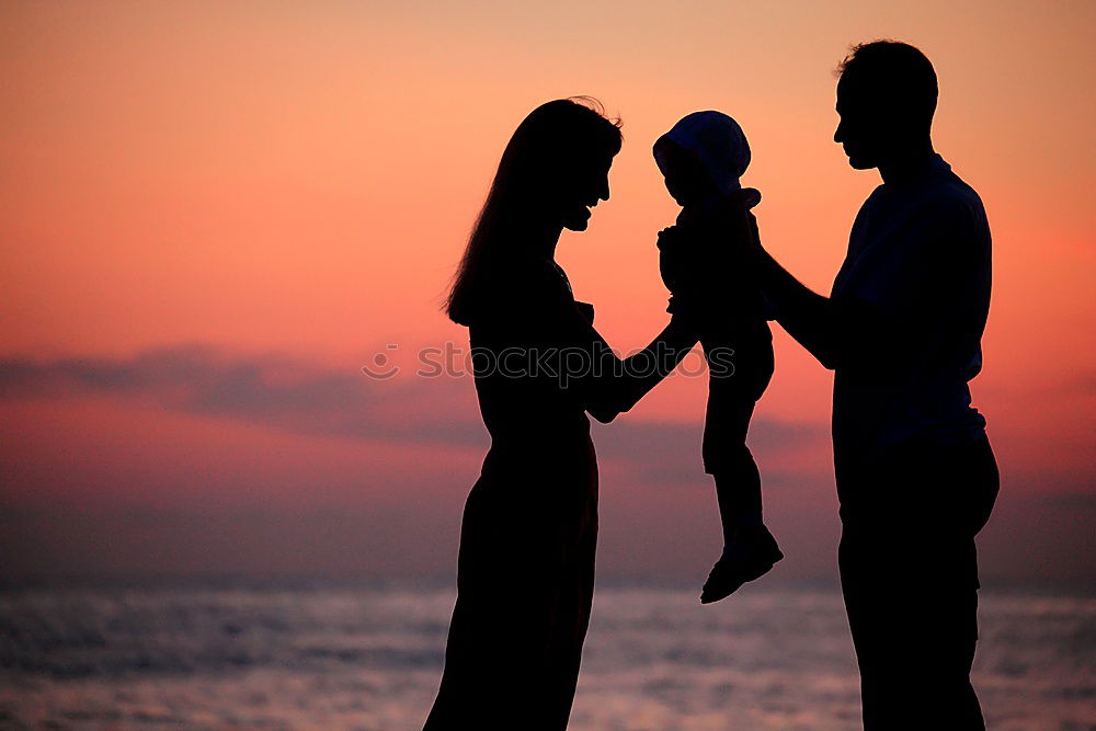 Similar – Father and son playing on the beach at the sunset time.